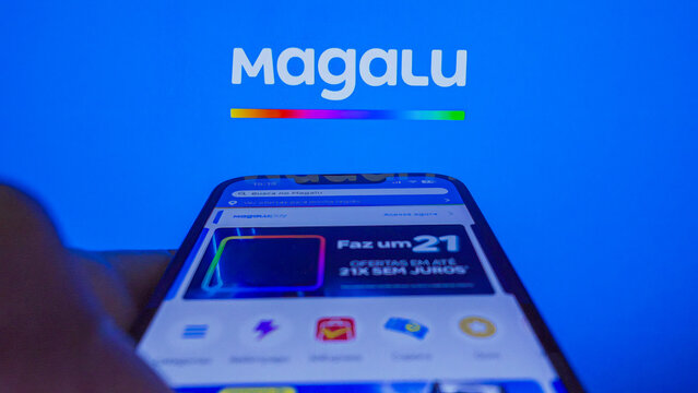 S&atilde;o Paulo, Brazil - January 27, 2025: A hand scrolls across a smartphone while using the Magalu app