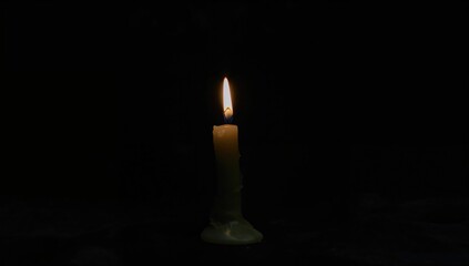 A candle placed on a dark surface, creating a serene atmosphere