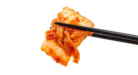Chopsticks holding a spicy piece of traditional korean kimchi food