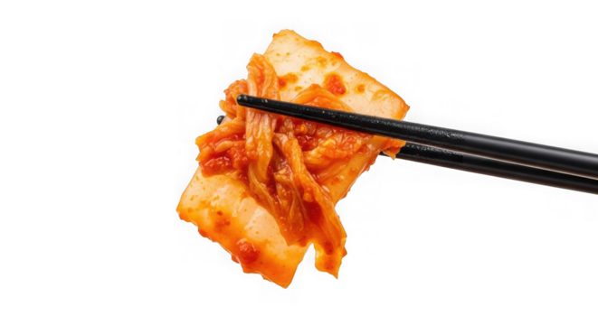 Chopsticks holding a spicy piece of traditional korean kimchi food