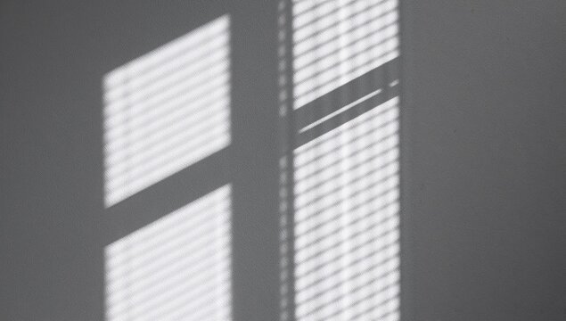 Abstract light and shadows, interplay of illumination and dark shapes on a white textured wall