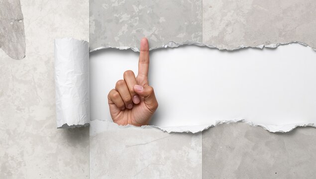 Human hand emerging through torn paper, making an upward pointing gesture. Space for text or branding. Symbol of communication or signaling. - Powered by Adobe