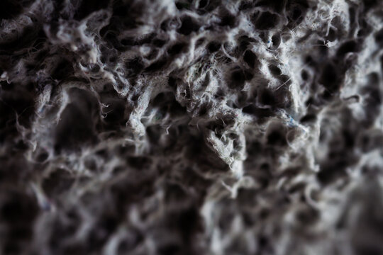 Extreme close up of old gray handmade paper clay with a structure and rough texture. Paper recycling. Selective soft focus, shallow depth of field. - Powered by Adobe