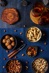 Bowls with nuts and blue table cloth on black chalkboard background. Flat lay. Top view.