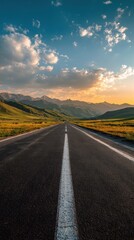 Naklejka premium Vibrant photo of picturesque road leading to mountains under a cloudy sky during sunset