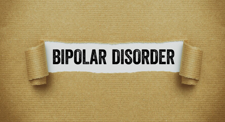 Torn paper revealing the word Bipolar disorder