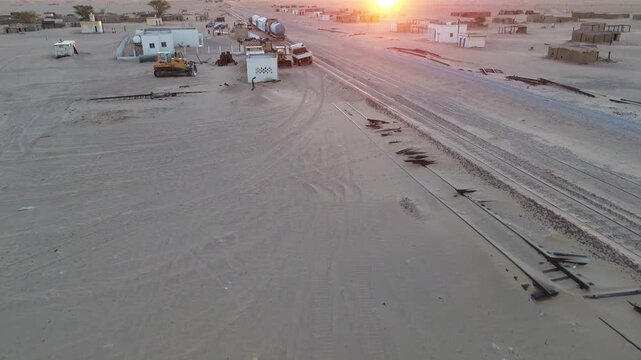 Freight train passing Ben Amera monolith at sunrise, Adrar, Mauritania