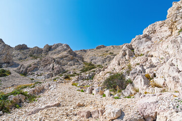 Rocky mountain landscape with clear blue sky and rugged terrain