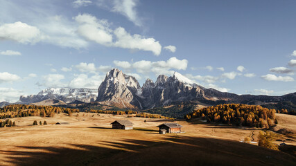 Place to live peaceful life, wooden houses. Tre Cime di Lavaredo, aerial view of majestic dolomites, mountains background