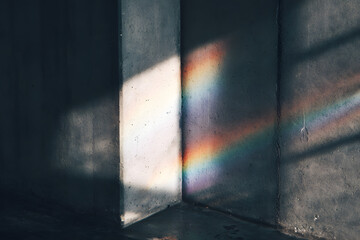 rainbow light refraction on textured wall with soft gradient shadows creating an ethereal minimalist vibe