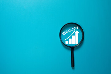 Concept of focusing on efficiency. Magnifying glass analyzes a growth chart icon, symbolizing business performance, productivity, and optimization. Blue background, copy space.