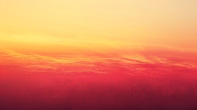 A gradient of colors from yellow to red in a smooth transition with some clouds