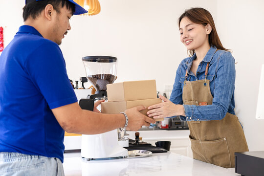Deliveryman confirming parcel with cafe owner woman using smartphone, representing digital signature, cashless payment, efficient collaboration between delivery service and small business logistics