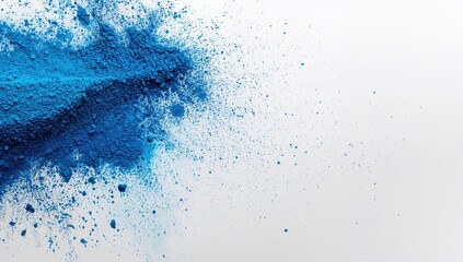 Blue powder particles scattered on a white surface, suitable for creative backgrounds