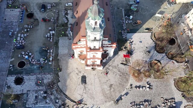 Kaunas Town Hall Square during renovation works in 2025. Construction equipment, workers and paving replacement visible. Aerial view of the historical old town public space. Editorial use only