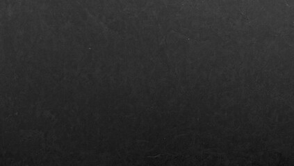Black graphite texture on cardboard, rough surface suitable for editorial header background