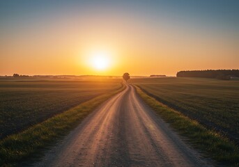 Sunrise over a rural road cutting through fields.
