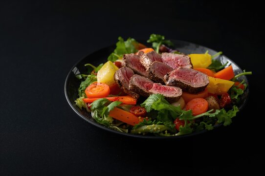 Tuna and carrot salad on a dark backdrop, fresh vegetables for a nutritious dish