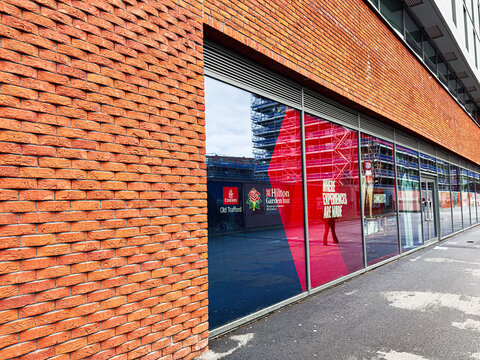 Modern brick building hilton garden inn with colorful glass storefronts in Manchester near Old Trafford