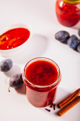 Homemade plum jam and fresh organic plums	