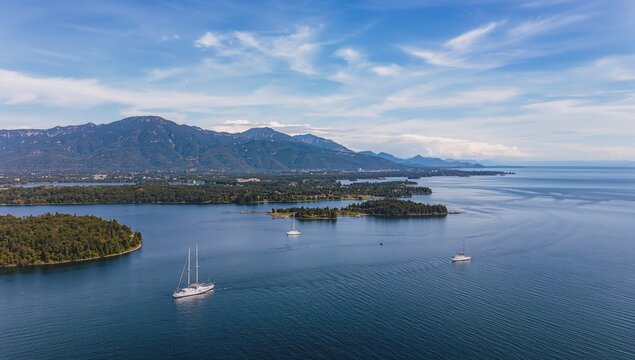 Picture showing distant boats used for sailing and fishing on a lake - Powered by Adobe