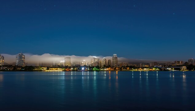 City skyline shrouded in night fog over water, suitable for business layouts - Powered by Adobe