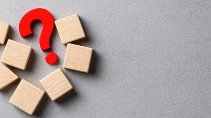 Explore innovative ideas with question marks on wooden blocks against a gray backdrop for social media inspiration