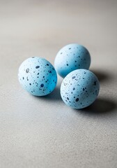 Speckled Blue Easter Eggs on a Neutral Surface.