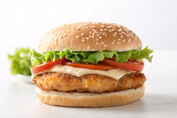 Delicious burger with fresh toppings beckons, promising a satisfying meal with juicy patty, crisp lettuce, and ripe tomatoes for lunch or dinner enjoyment.