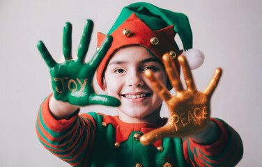 Smiling Elf Children with Joy and Peace Painted on Hands for Christmas and Holiday Celebrations