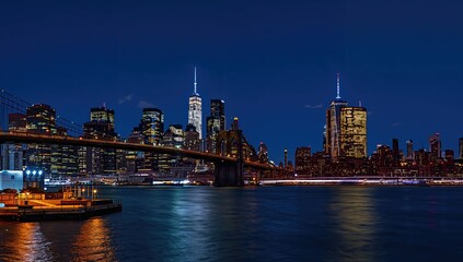 Cityscape featuring a river and iconic suspension bridge at sunset