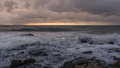 Fototapeta premium Vertical image of ocean waves hitting rocky shoreline, showcasing erosion risk