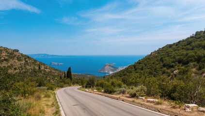 Aerial view of a winding road leading to a village, showcasing the lush slopes of a coastal region, highlighting seasonal beauty