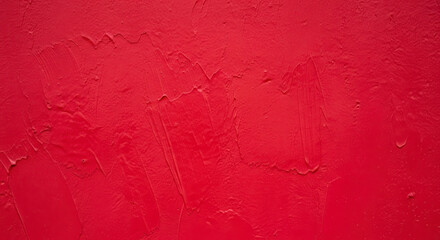Close up of a cracked vibrant red painted wall texture