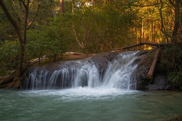 Fototapeta premium Water cascading down the multi-tiered cascade in southern Thailand