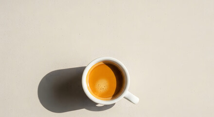 Wide top-down frame with empty space a single espresso cup on a neutral background