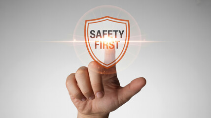 A hand touching a safety first shield with a bright light on a white background in a digital illustration