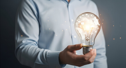 Man holding a light bulb representing an idea or innovation.