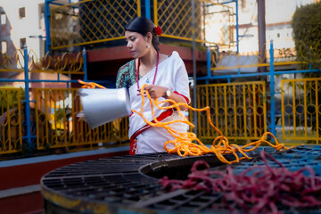 Newari Girl in tradional attire Drawing Water from a Traditional Hiti