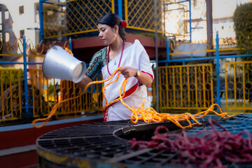 Newari Girl in tradional attire Drawing Water from a Traditional Hiti
