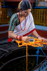 Newari Girl in tradional attire Drawing Water from a Traditional Hiti