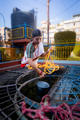 Newari Girl in tradional attire Drawing Water from a Traditional Hiti