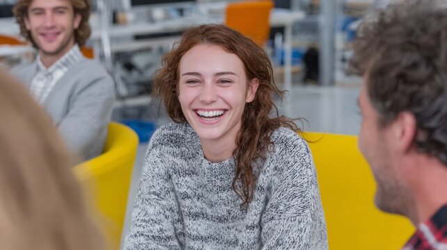 Joyful laughter fills the office as a young Caucasian woman radiates happiness, perfect for World Laughter Day festivities