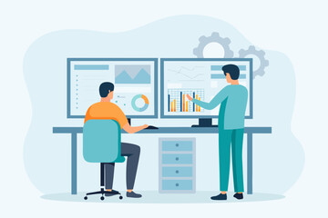 Two colleagues collaborating and analyzing data on multiple computer screens in an office setting
