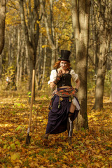 Fototapeta premium Portrait of young woman in Halloween carnival costume in autumn park.
