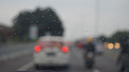 Rainy Car Window with Blurred Traffic Lights Bokeh