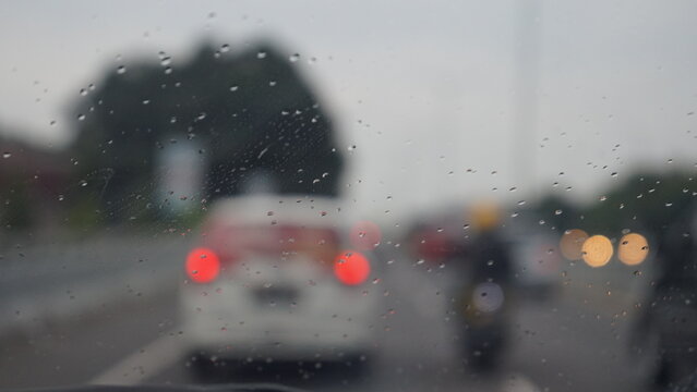 Rainy Car Window with Blurred Traffic Lights Bokeh