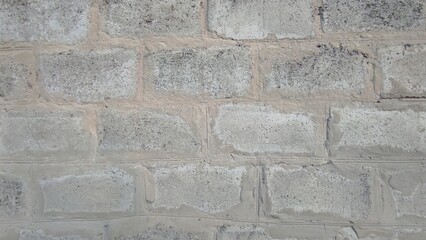 Gray Concrete Wall With Rough Texture and Uneven Surfaces in Urban Setting