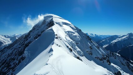 A majestic mountain with a snow covered peak stretches towards the sky as a thrill seeking skier glides effortlessly down its slopes and a daring snowboarder carves through the snowy terrain.