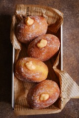 top view of bomboloni with cream filling against dark background 